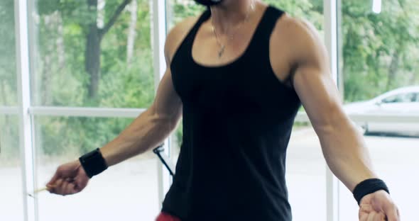 Athletic Man Working Out with a Jump-rope. Close Up, Slow Motion