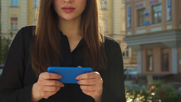 Girl Message on Her Phone Outdoors