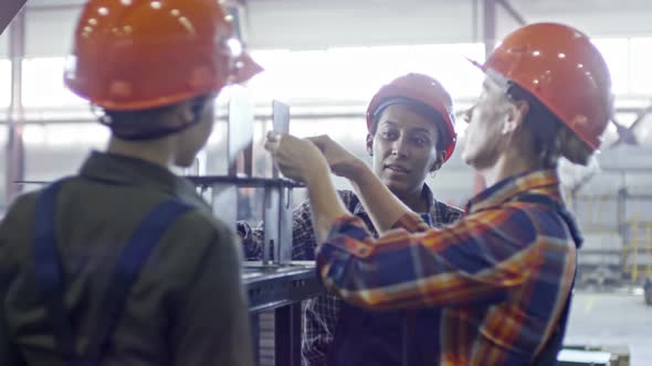 Female Factory Workers Using Caliper