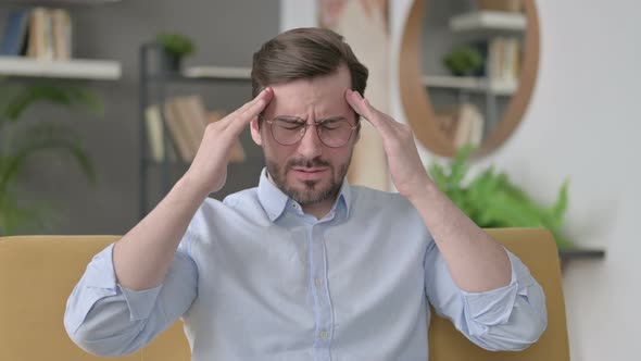 Portrait of Young Man Having Headache at Home