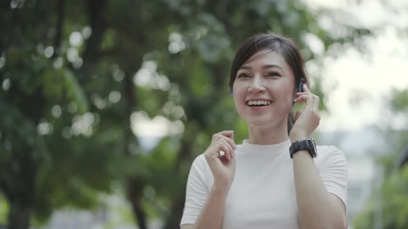 woman walking and listening to music with wireless headphones