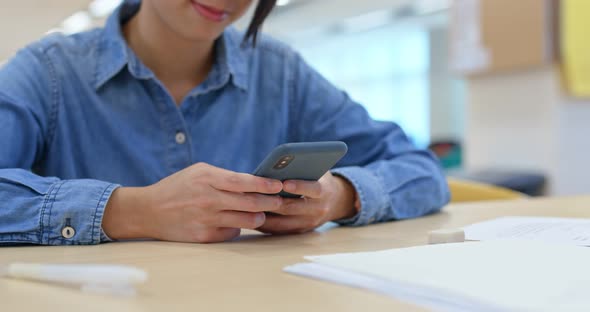 Woman use of cellphone at library