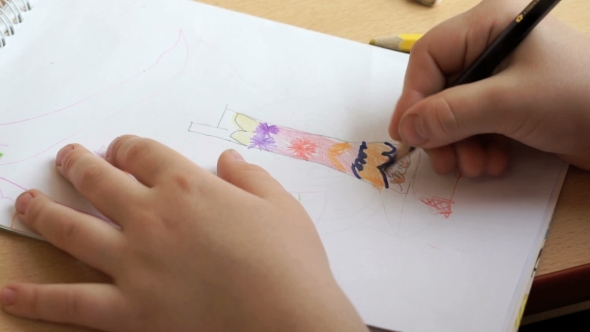 Little Girl Draws a Pictures In The Copybook