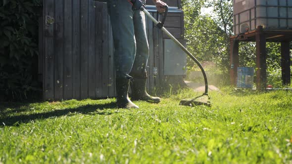 Male Gardener Mowing Green Lawn with Manual Gas Grass Mower Garden Maintenance