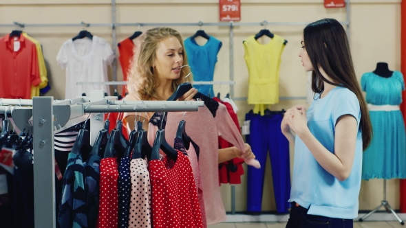 Girlfriends Choose Clothes In Shop