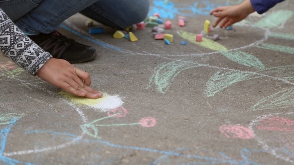 Children Draw with Chalk on the Asphalt