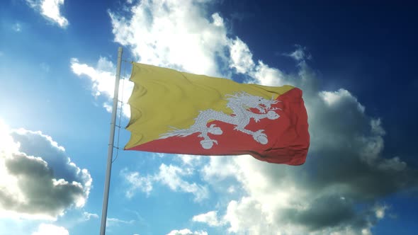 Flag of Bhutan Waving at Wind Against Beautiful Blue Sky