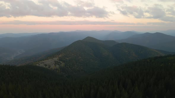 Aerial View of Amazing Scenery with Foggy Dark Mountain Peak Covered with Forest Pine Trees at