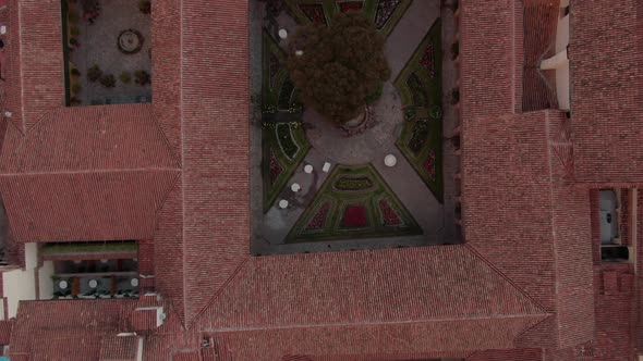 4K aerial view over a beautiful decorated inside garden of a spanish colonial house in the city cent