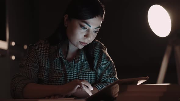 Woman Writing Notes in Notebook