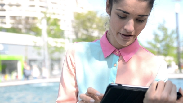 Young Woman In City With Tablet PC