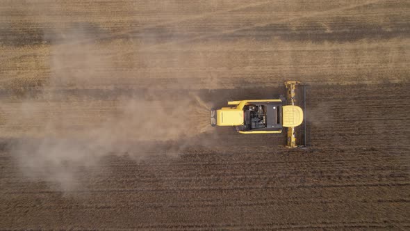 Aerial View of Harvester Machines Working in Wheat Field