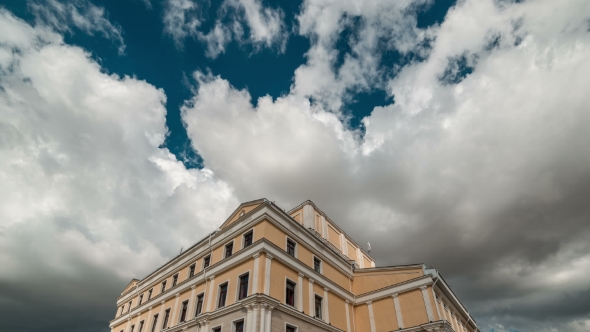 Large White Cloud In The Blue Sky Over The Building Of The Theater. Kazakhstan