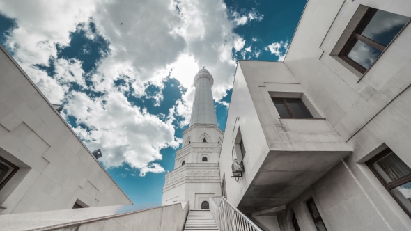 The Sun Breaks Through the Clouds Over a White Mosque. Kazakhstan
