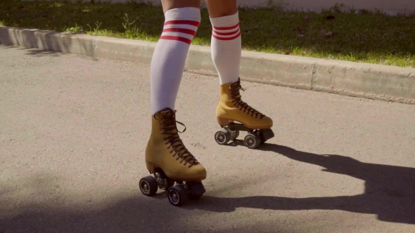 Female Legs On Vintage Roller Skater On The Road.