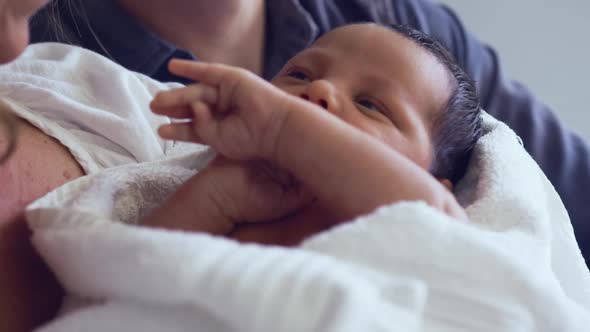 Close-up of Caucasian couple holding their newborn baby in the ward at hospital