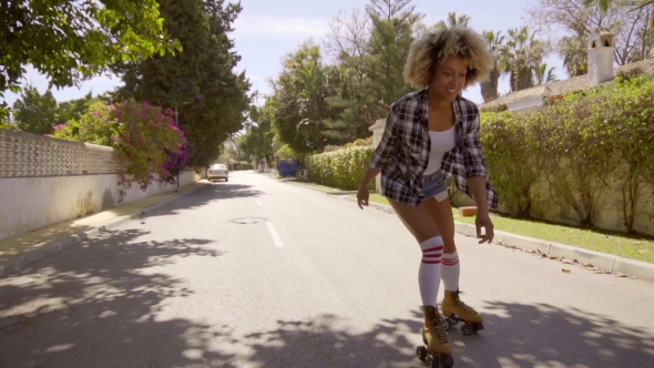 Young Woman On Roller Skates Enjoying The Summer