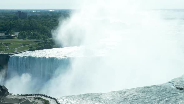 A medium shot of mist rising over Horseshoe Falls in Niagara Falls, Ontario.