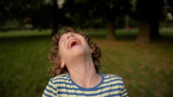 Cute Boy Laughing In The Park