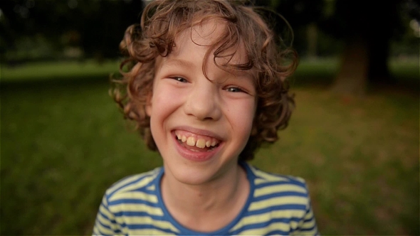 Cute Boy Laughing In The Park