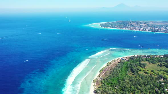 Aerial drone sky of tropical seashore beach break by clear lagoon with white sandy background of a d