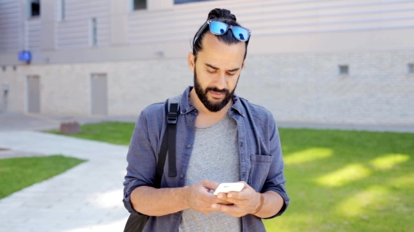 Man With Backpack Texting On Smartphone In City 30