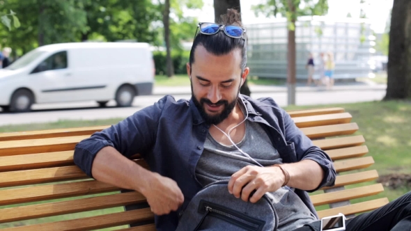 Man With Backpack And Earphones In City 17