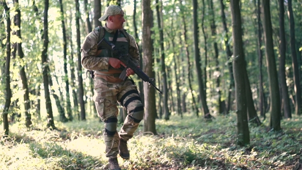 Military Man Starts To Shoot In The Forest