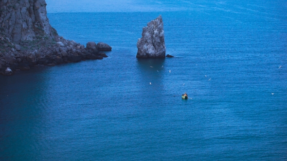 Fishermen In a Small Boat In The Sea.