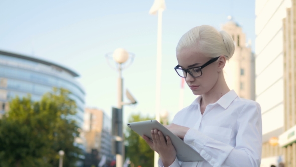 Portrait Of Young Beautiful Business Woman Using Tablet PC Outdoors
