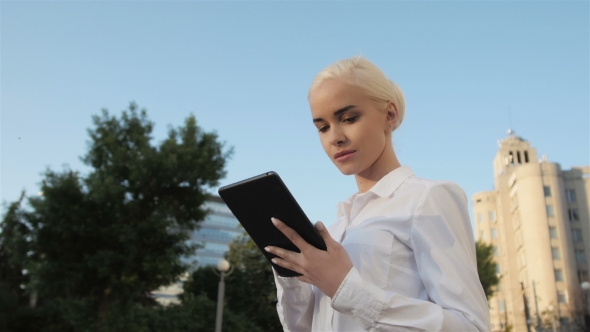 Portrait Of Young Beautiful Business Woman Using Tablet PC Outdoors