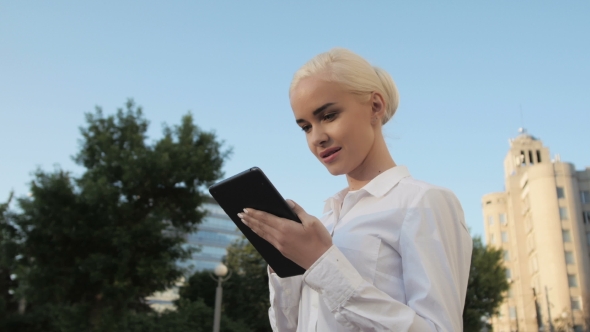 Portrait Of Young Beautiful Business Woman Using Tablet PC Outdoors