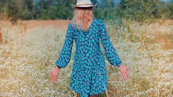 Happy Woman Walking On Summer Field.Hand Touches Wild Grass.Girl On Meadow.Summer Leisure Vacation