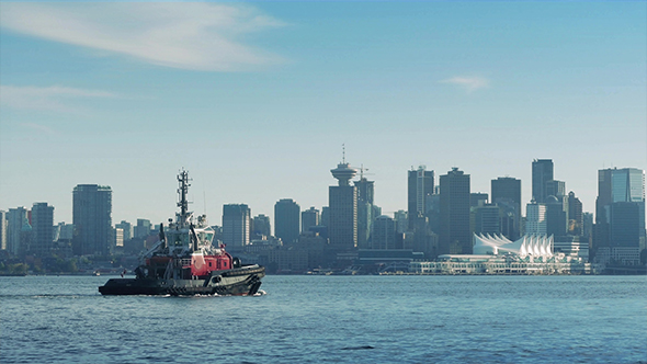 Boat Passing Near City Waterfront