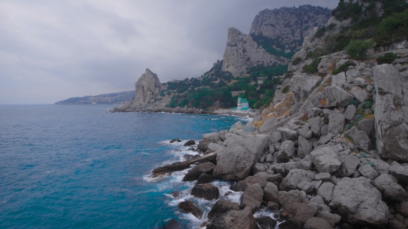 Catholic And Protestant Church On The Beach, At The Foot Of The Mountain.