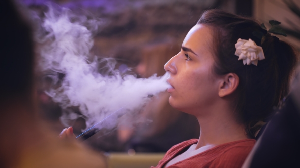 Nice Girl In a Nightclub Smokes a Hookah.