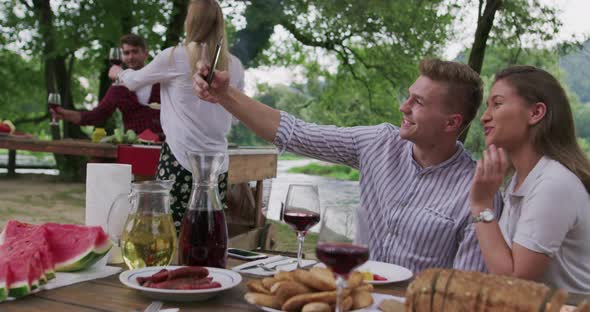 Young Happy Couple Taking Selfie While Having Picnic French Dinner Party Outdoor During Summer