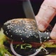 A Man Cuts a Huge Burger with a Knife - VideoHive Item for Sale