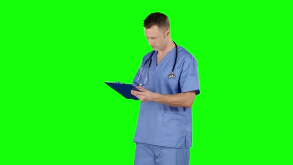 Doctor Takes Notes. Green Screen