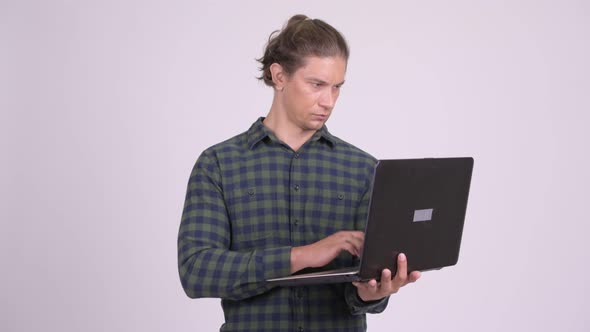 Happy Hipster Man Smiling While Using Laptop