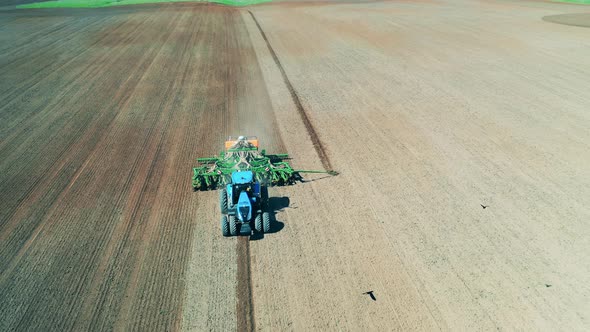 View of a Tractor, Sowing a Big Field.