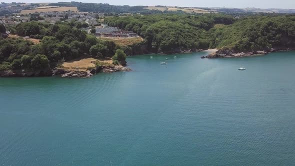 Beautiful aerial dolly in with zoom effect towards a bay on the English Channel.
