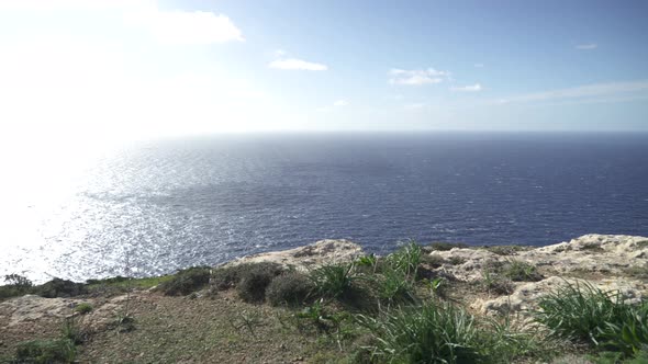Dingli Cliffs Panorama with Blue Mediterranean Sea in Background and Very Bright Sun