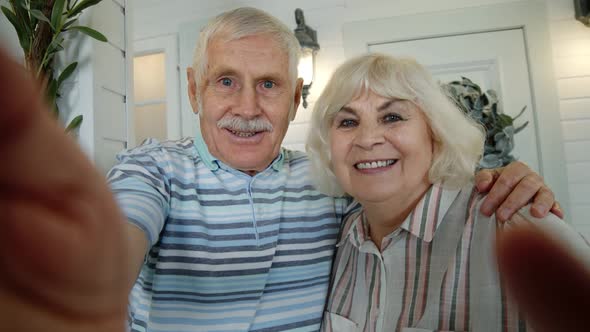 Senior Elderly Caucasian Couple Using Mobile Phone for Video Call, Making Selfie in Porch at Home