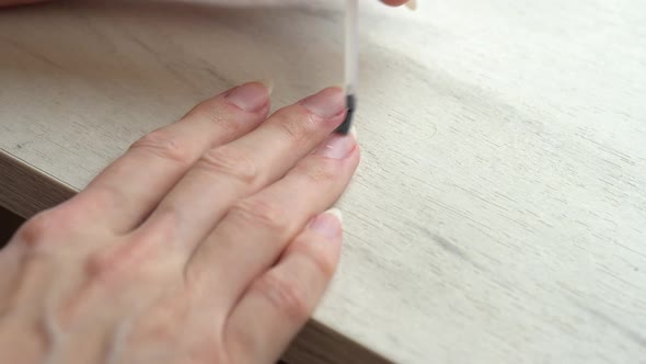 Applying a Base Coat Before Coating Nails with Nail Polish Self Manicure at Home