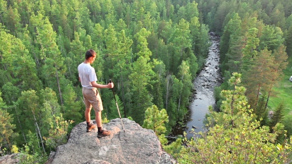 Hiker Man Standing On Top Of a Mountain