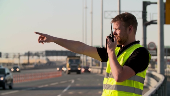 Traffic Police With Walkie Talkie Work At Highway