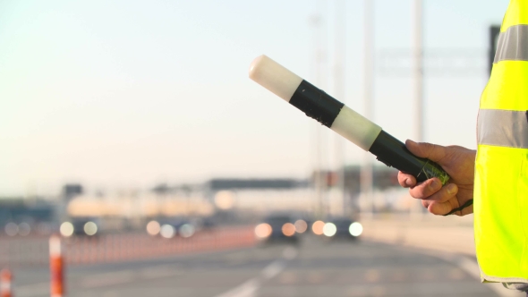 Traffic Police With Traffic Rod Isolated And Walkie Talkie Work At Highway