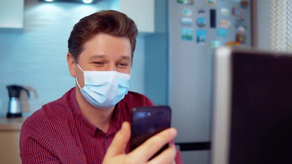 Masked Man Makes a Video Call on the Phone