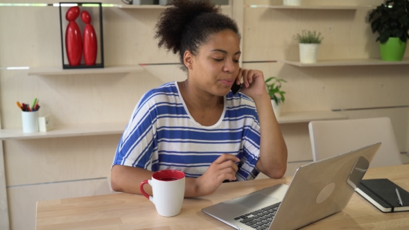 Happy Mixed Race Woman Working At The Office.